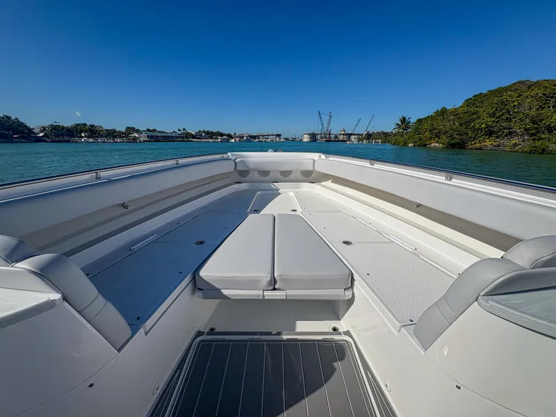 Slide: The Image of 2024 HCB 53' Suenos boat deck with seating, on calm water under clear blue sky. - 30