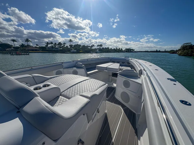 Slide: The Image of 2024 HCB 53' Suenos luxury boat with spacious seating on a sunny day. - 37