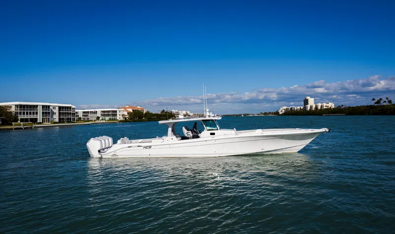 Slide: The Image of 2024 HCB 53' Suenos boat on calm water with clear blue sky. - 4