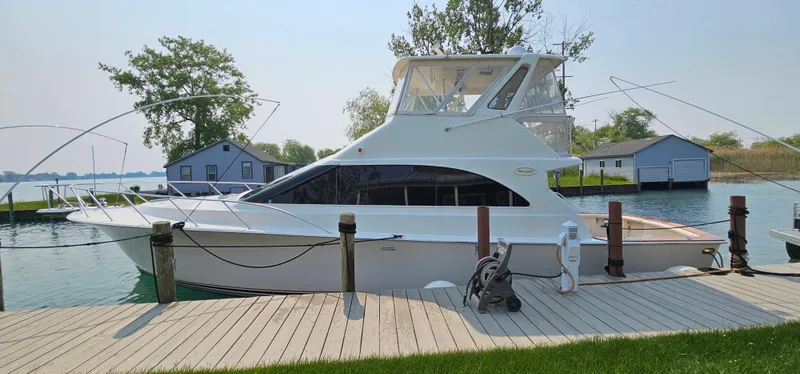 Slide: The Image of 1997 Ocean Yachts 48 Super Sport docked on a sunny day. - 2