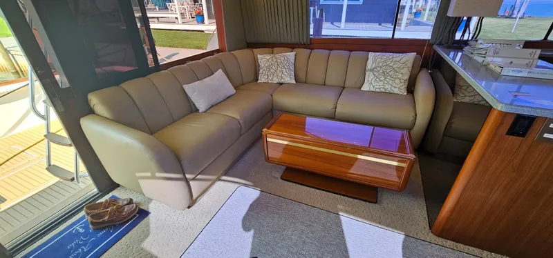 Slide: The Image of Interior of 1997 Ocean Yachts 48 Super Sport with leather sofa and wooden table. - 28