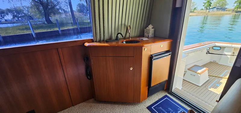 Slide: The Image of Interior of 1997 Ocean Yachts 48 Super Sport with minibar and water view. - 34