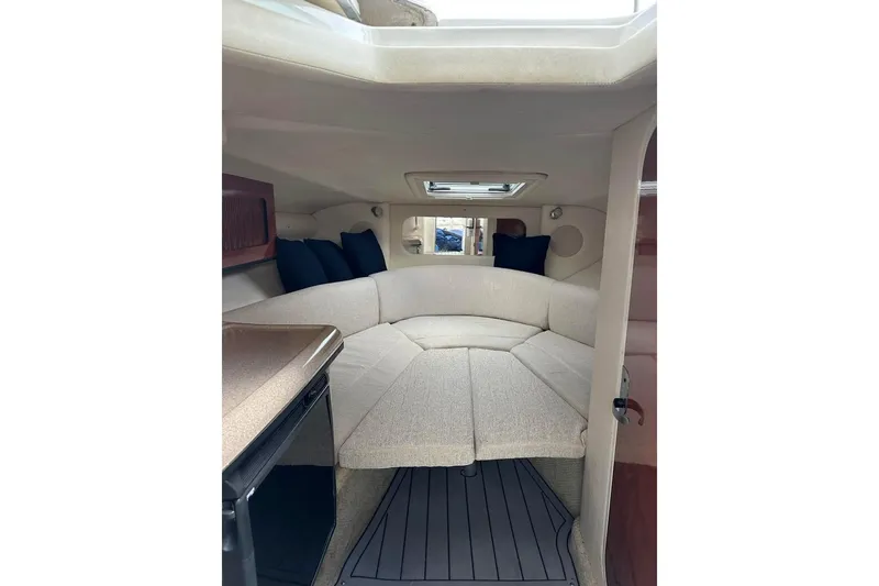 Slide: The Image of Interior of 2007 Sea Ray 290 Sun Sport boat with cozy seating and cushions. - 11