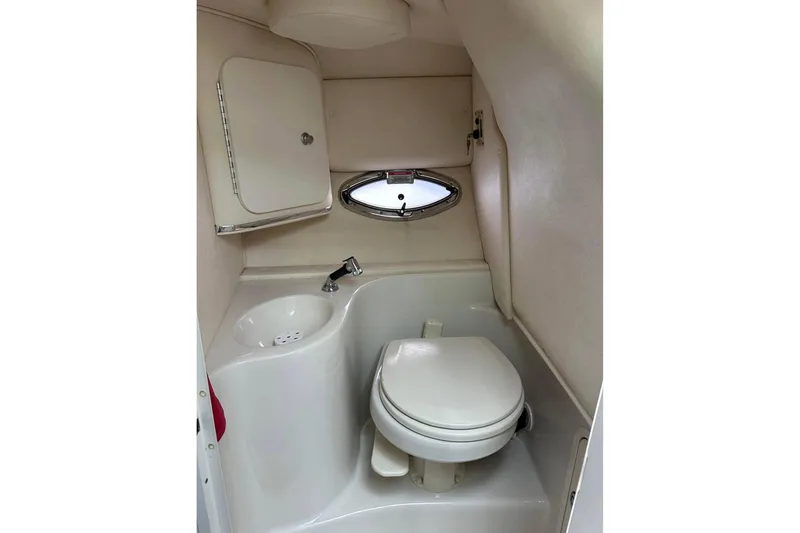 Slide: The Image of 2007 Sea Ray 290 Sun Sport boat bathroom with sink, toilet, and small window. - 13