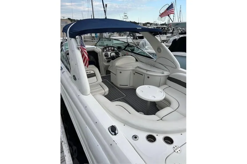Slide: The Image of 2007 Sea Ray 290 Sun Sport boat interior with seating and American flag. - 3