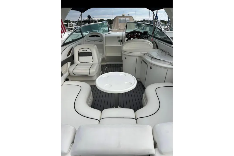 Slide: The Image of 2007 Sea Ray 290 Sun Sport boat interior with white seating and round table. - 4