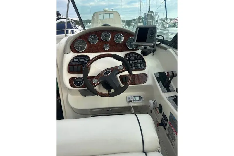 Slide: The Image of 2007 Sea Ray 290 Sun Sport boat dashboard with steering wheel and navigation controls. - 5