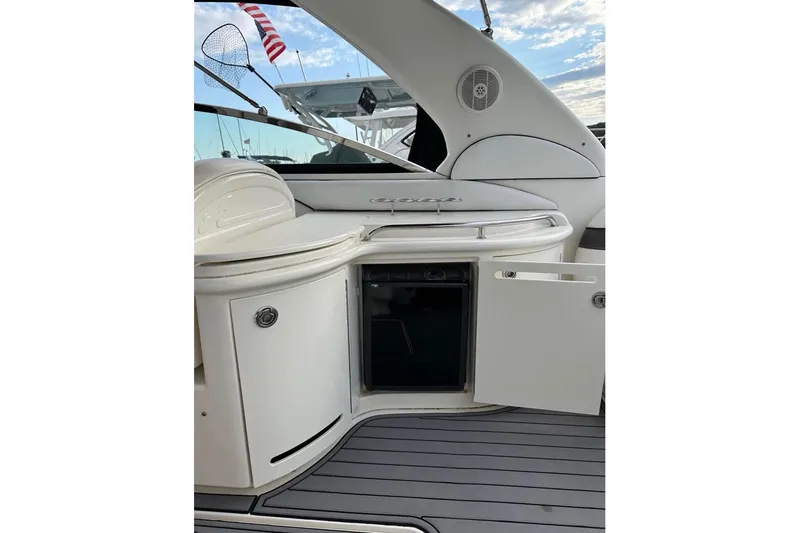 Slide: The Image of 2007 Sea Ray 290 Sun Sport boat interior with open cabinet and sleek design. - 6