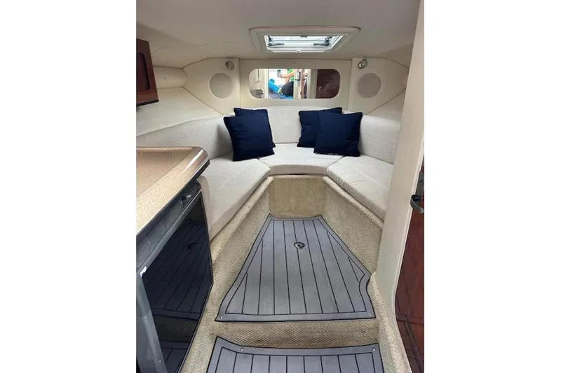 Slide: The Image of 2007 Sea Ray 290 Sun Sport cabin interior with seating and cushions. - 9