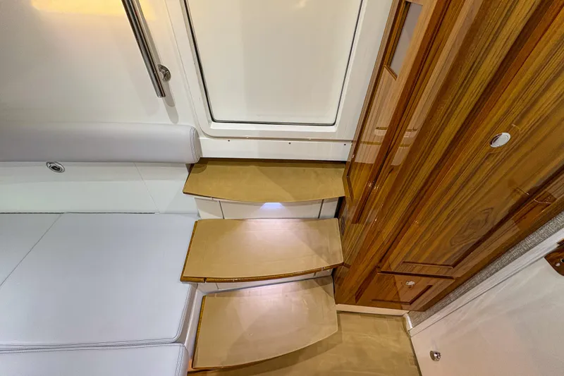 Slide: The Image of Interior of 2024 HCB 53' Suenos, featuring wooden steps and sleek seating. - 14