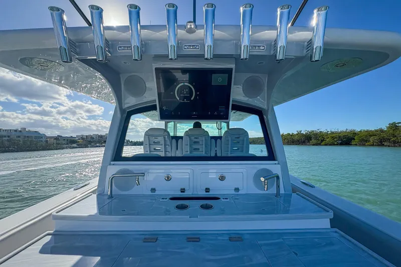 Slide: The Image of 2024 HCB 53' Suenos luxury boat interior with fishing rod holders and navigation screen. - 48