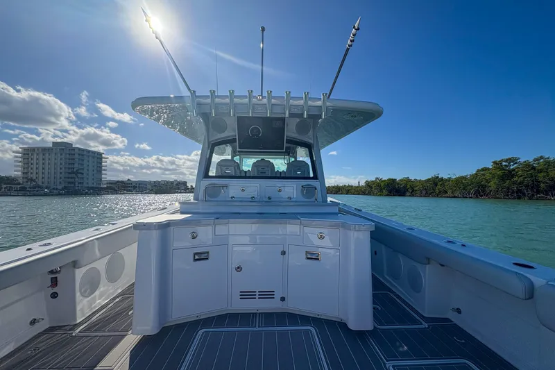 Slide: The Image of 2024 HCB 53' Suenos boat on water, sunny day, clear sky, modern design. - 52