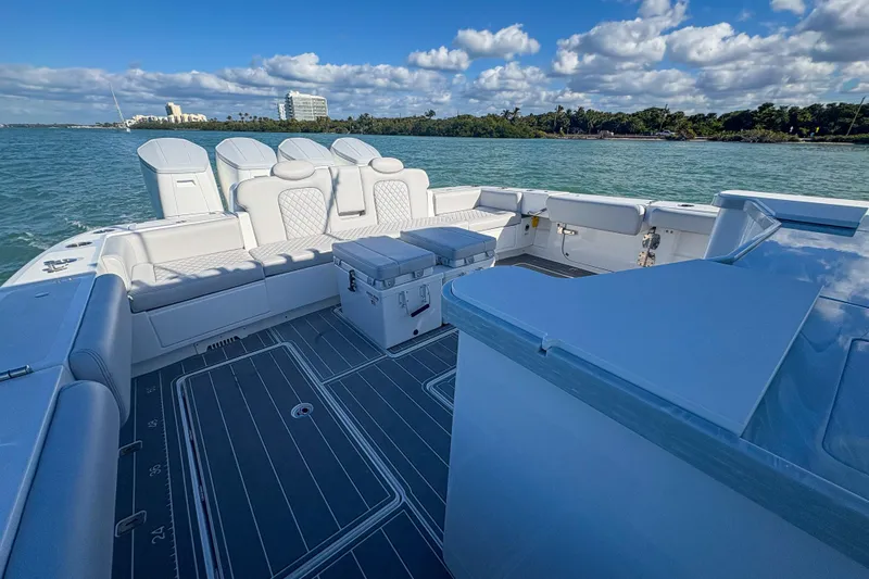 Slide: The Image of 2024 HCB 53' Suenos boat interior with seating, ocean view, and clear skies. - 56