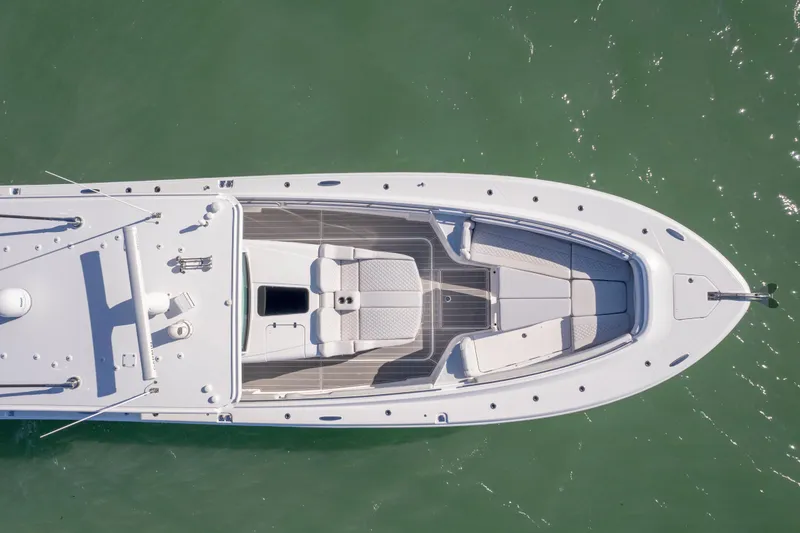 Slide: The Image of Aerial view of 2024 HCB 53' Suenos luxury yacht on calm green water. - 57