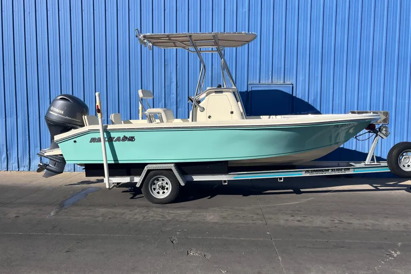 Slide: The Image of 2015 Release 190RX boat on trailer, blue hull, Yamaha outboard, against blue wall. - 3