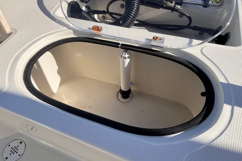 Slide: The Image of Open storage compartment on 2015 Release 190RX boat, featuring a clean interior. - 6