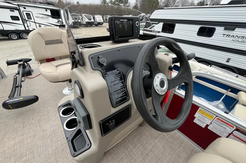 Slide: The Image of 2025 Sun Tracker Bass Buggy 18 DLX boat interior with steering wheel and control panel. - 10