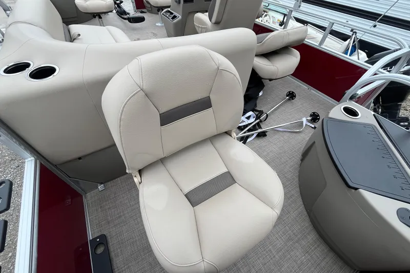 Slide: The Image of 2025 Sun Tracker Bass Buggy 18 DLX interior with beige seating and cup holders. - 14