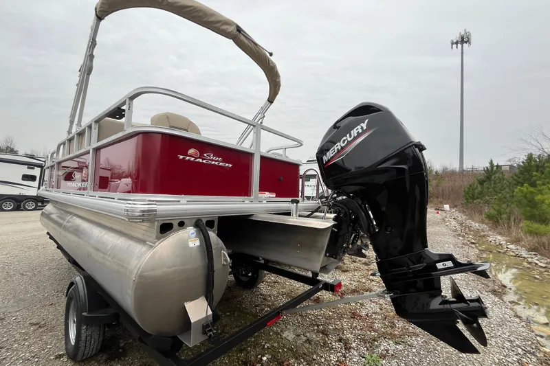 Slide: The Image of 2025 Sun Tracker Bass Buggy 18 DLX pontoon boat with Mercury outboard motor. - 19