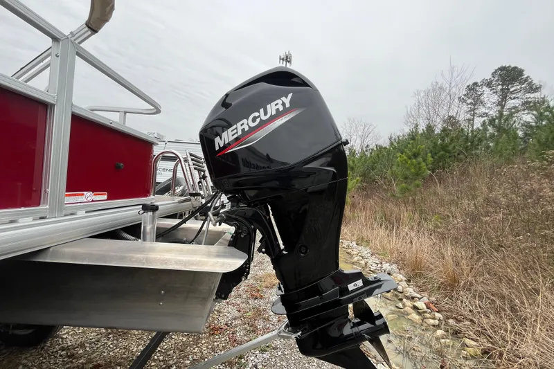 Slide: The Image of 2025 Sun Tracker Bass Buggy 18 DLX with Mercury outboard motor, parked outdoors. - 20