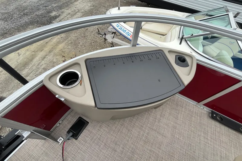 Slide: The Image of 2025 Sun Tracker Bass Buggy 18 DLX fishing station with cup holders and measuring board. - 6