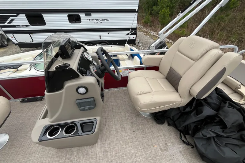 Slide: The Image of 2025 Sun Tracker Bass Buggy 18 DLX boat interior with steering console and comfortable seating. - 9