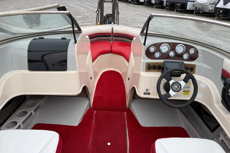 Slide: The Image of 1995 Donzi 212 Medallion boat interior with red and white seating, dashboard, and steering wheel. - 10