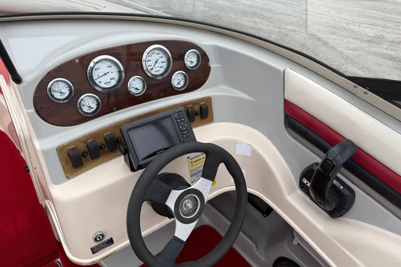 Slide: The Image of 1995 Donzi 212 Medallion boat dashboard with gauges and steering wheel. - 11