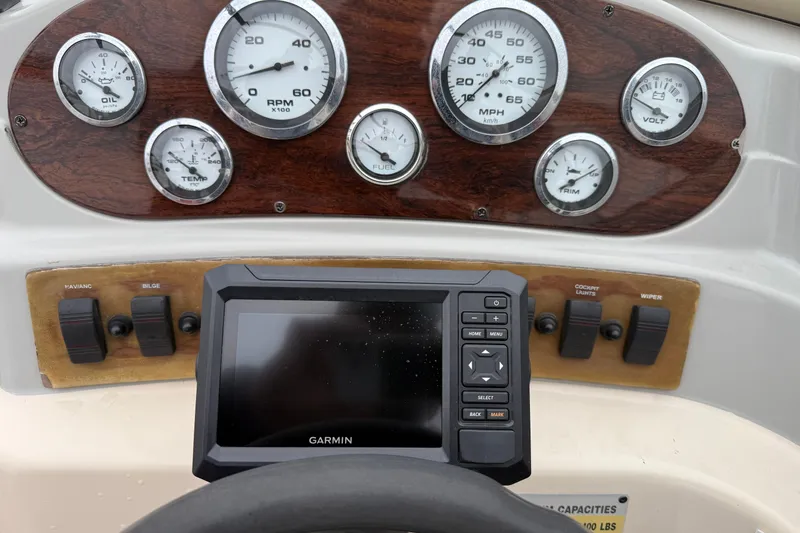 Slide: The Image of Dashboard of a 1995 Donzi 212 Medallion boat with gauges and Garmin device. - 12