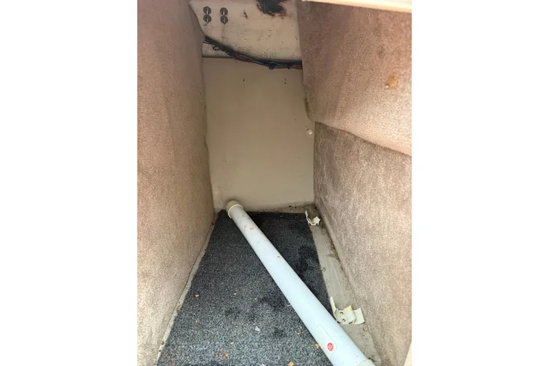 Slide: The Image of Interior view of a 1995 Donzi 212 Medallion boat compartment with visible piping. - 15