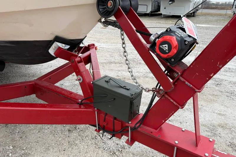 Slide: The Image of Red trailer hitch with winch and chain securing a 1995 Donzi 212 Medallion boat. - 18
