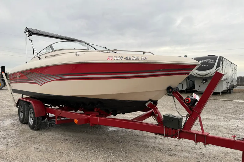 Slide: The Image of 1995 Donzi 212 Medallion boat on red trailer, parked outdoors. - 4
