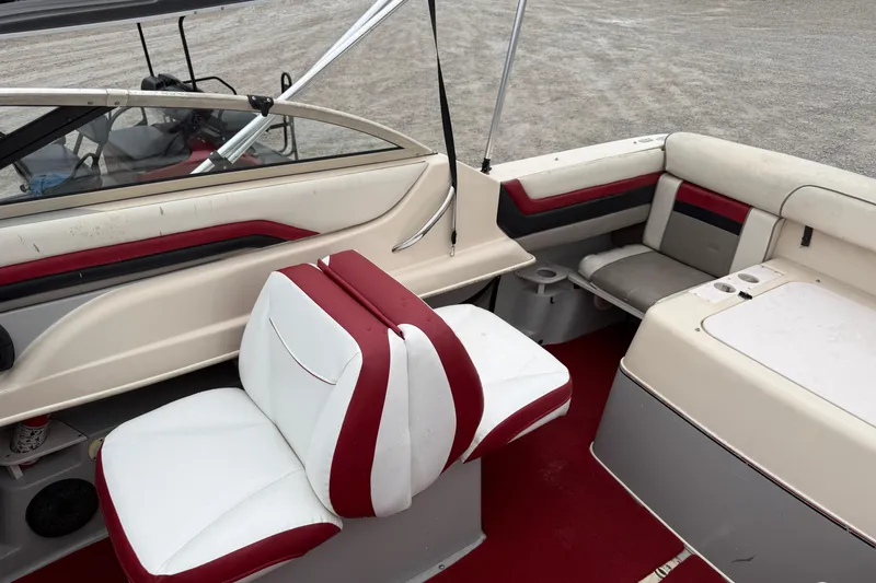 Slide: The Image of 1995 Donzi 212 Medallion boat interior with red and white seating and dashboard. - 9