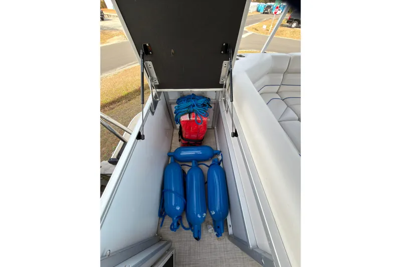 Slide: The Image of 2021 SunCatcher Select 20C boat storage with blue fenders and red bag. - 10