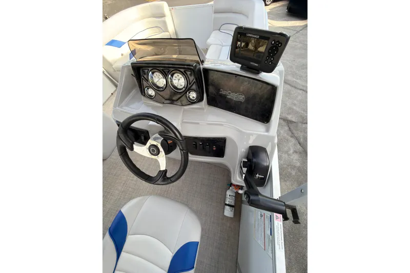 Slide: The Image of 2021 SunCatcher Select 20C boat dashboard with steering wheel and navigation system. - 11