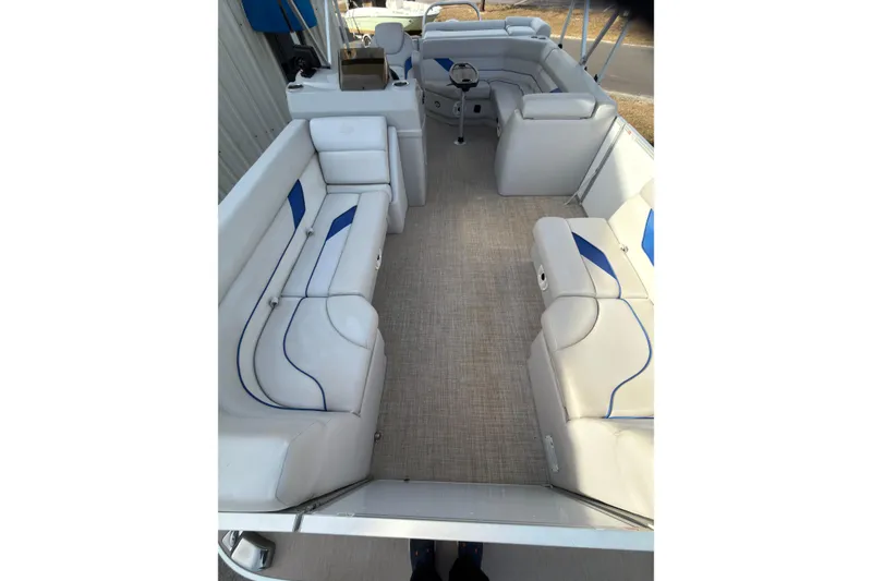 Slide: The Image of Interior of 2021 SunCatcher Select 20C pontoon boat with white and blue seating. - 12