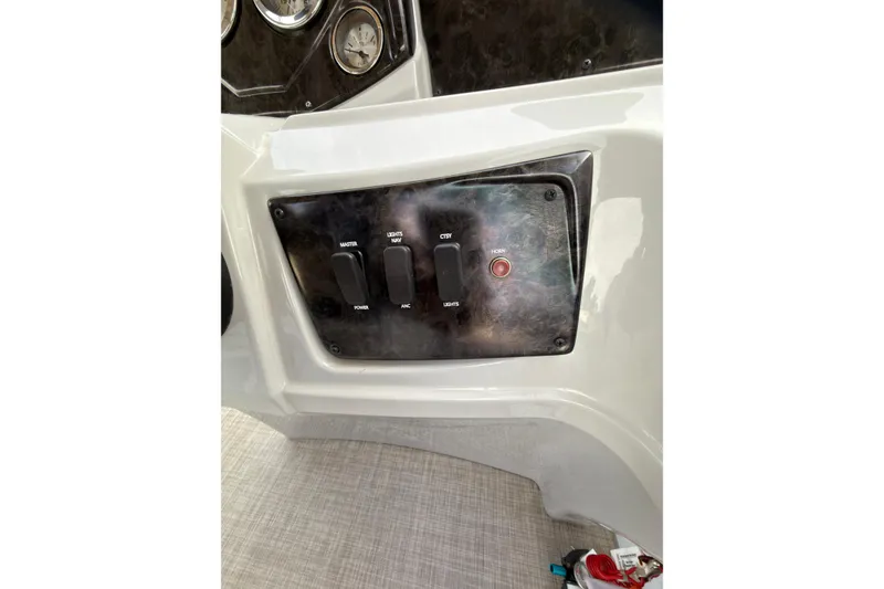 Slide: The Image of Control panel of 2021 SunCatcher Select 20C boat with switches and gauges. - 14