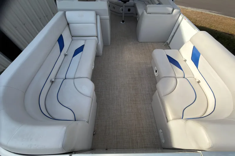 Slide: The Image of Interior of 2021 SunCatcher Select 20C pontoon boat with white and blue seating. - 6