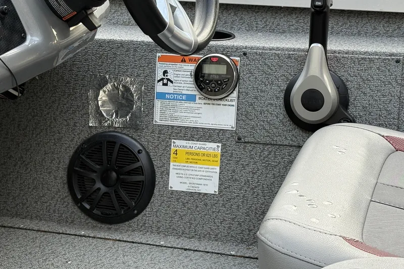 Slide: The Image of 2021 G3 Sportsman 1810 boat interior with steering wheel, controls, and capacity label. - 10