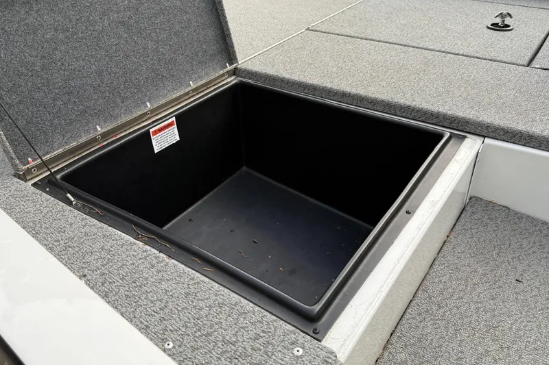 Slide: The Image of 2021 G3 Sportsman 1810 boat storage compartment with open lid, showing spacious interior. - 11