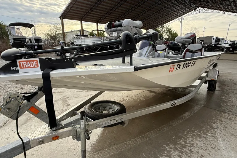 Slide: The Image of 2021 G3 Sportsman 1810 boat on trailer, under a canopy, with trade sticker. - 13