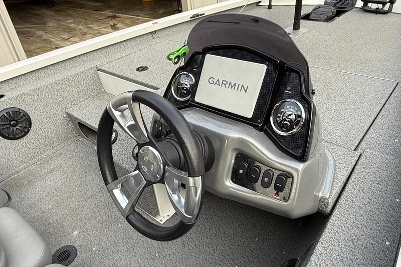 Slide: The Image of 2021 G3 Sportsman 1810 boat dashboard with Garmin navigation system and steering wheel. - 5