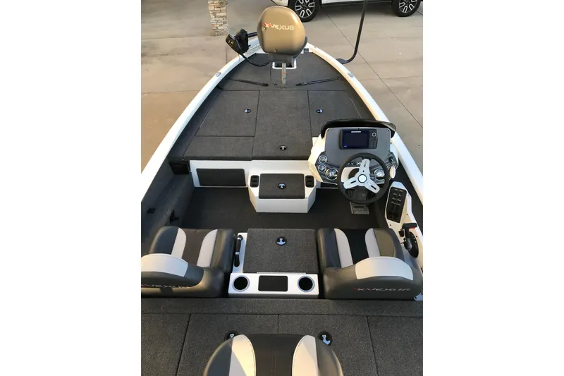 Slide: The Image of 2022 Vexus AVX1880 boat interior with steering console and seating. - 2