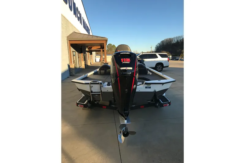 Slide: The Image of 2022 Vexus AVX1880 boat with Mercury 115 outboard motor, parked outdoors. - 5