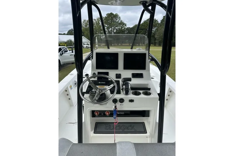 Slide: The Image of 2022 BlackJack 256 Bay boat console with steering wheel, controls, and display screens. - 4