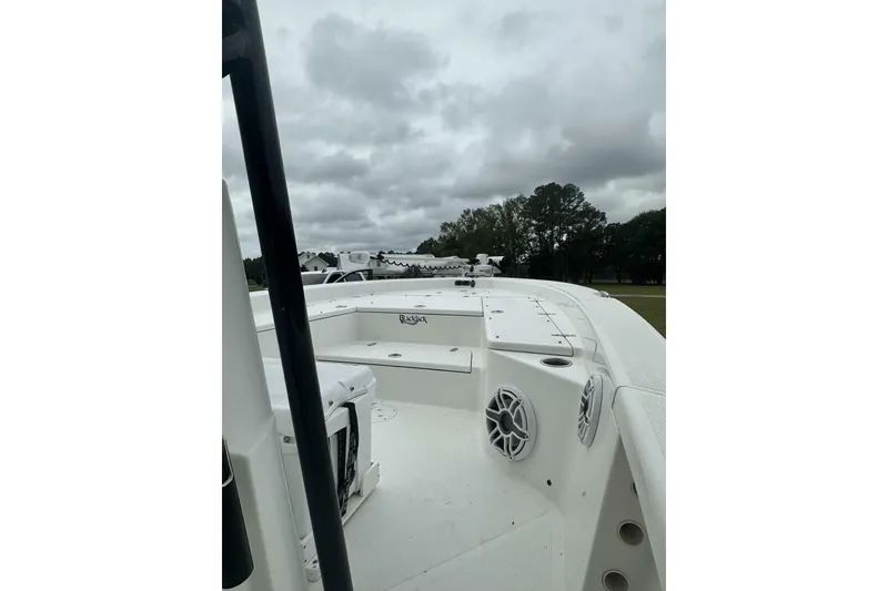 Slide: The Image of 2022 BlackJack 256 Bay boat deck with speakers, under cloudy sky. - 5