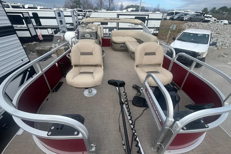 Slide: The Image of 2025 Sun Tracker Bass Buggy 16 XL Select pontoon boat with beige seating and red panels. - 10