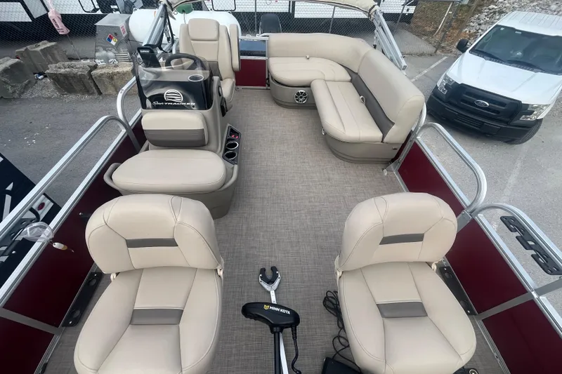 Slide: The Image of 2025 Sun Tracker Bass Buggy 16 XL Select pontoon boat interior with beige seating and steering console. - 11