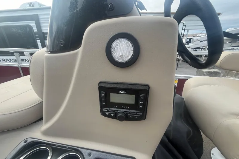 Slide: The Image of 2025 Sun Tracker Bass Buggy 16 XL Select dashboard with audio controls and speaker. - 14