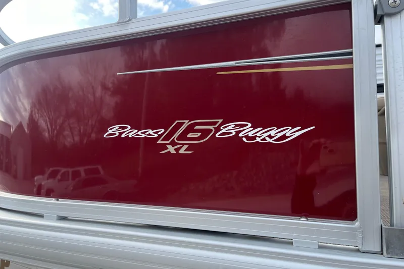 Slide: The Image of 2025 Sun Tracker Bass Buggy 16 XL Select, maroon panel with logo and reflection. - 3